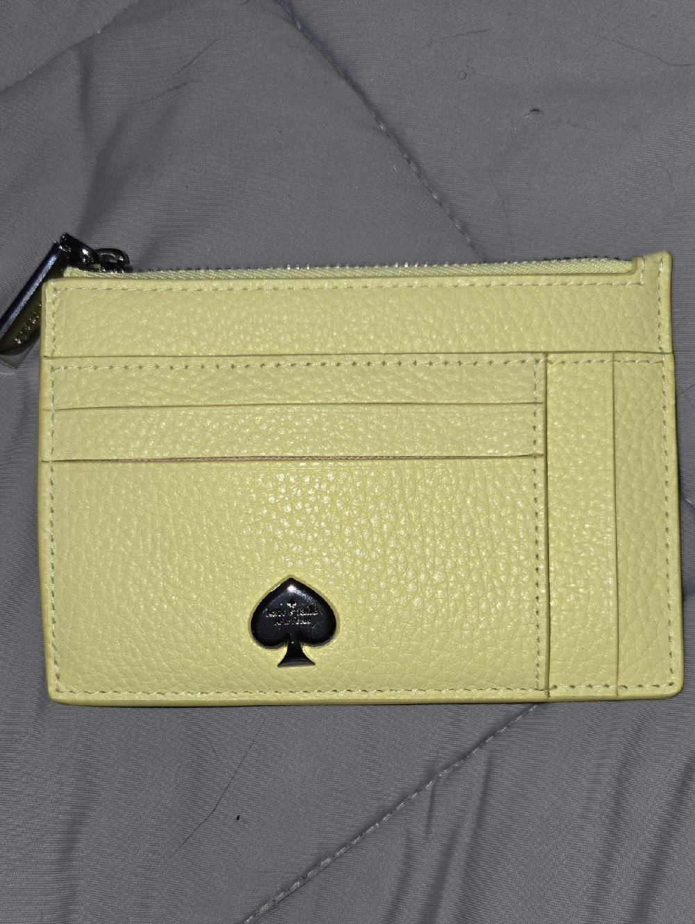 Kate Spade Kayla Tennis Ball yellow pebble leather card case with spade emblem